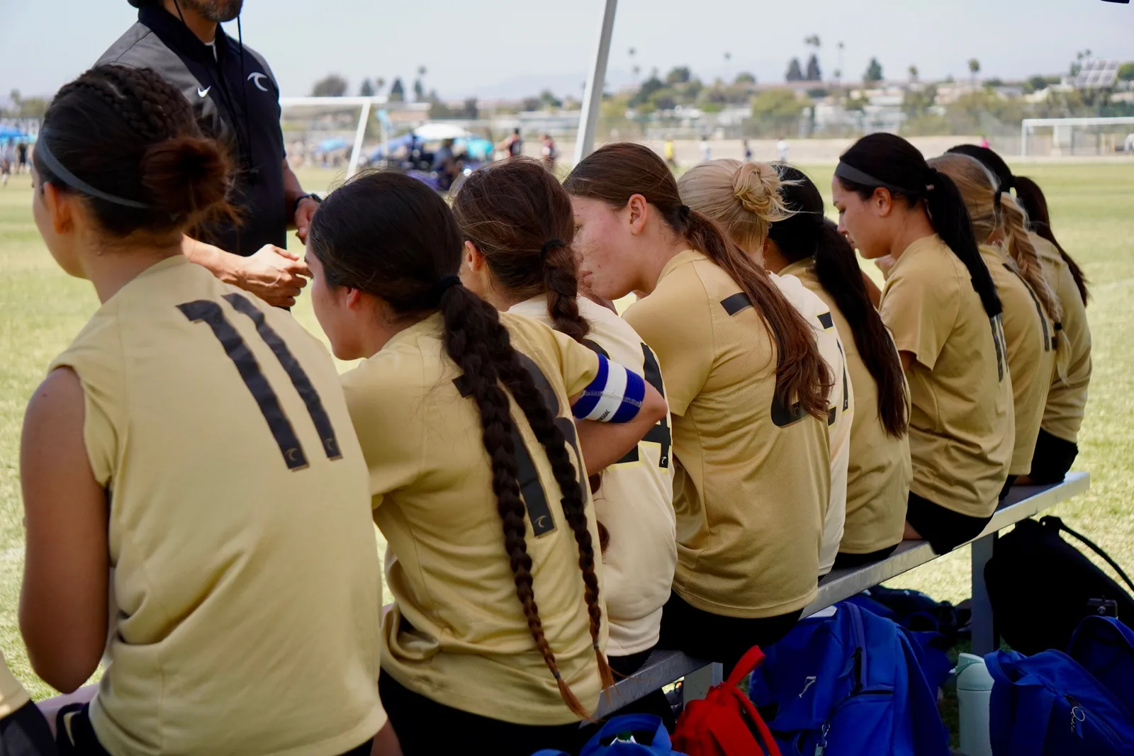 South Valley Surf girls watching from the bench during a match